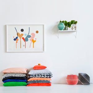 Two stacks of Castle Cushions in White Room with Large Painting by Rachel Castle and Shelf With Pots by Castle